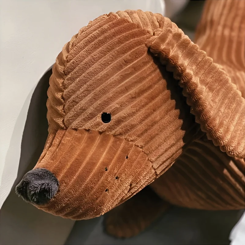 Ergonomisk pude i plysch formet som en gravhund