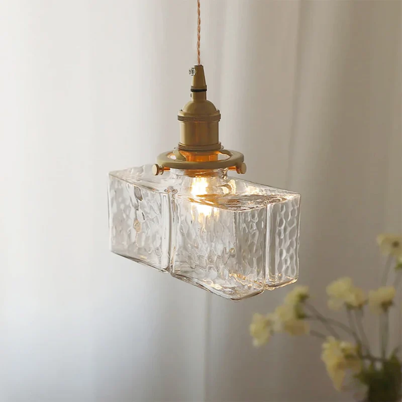Elegant glaspendel med geometrisk design og varm belysning